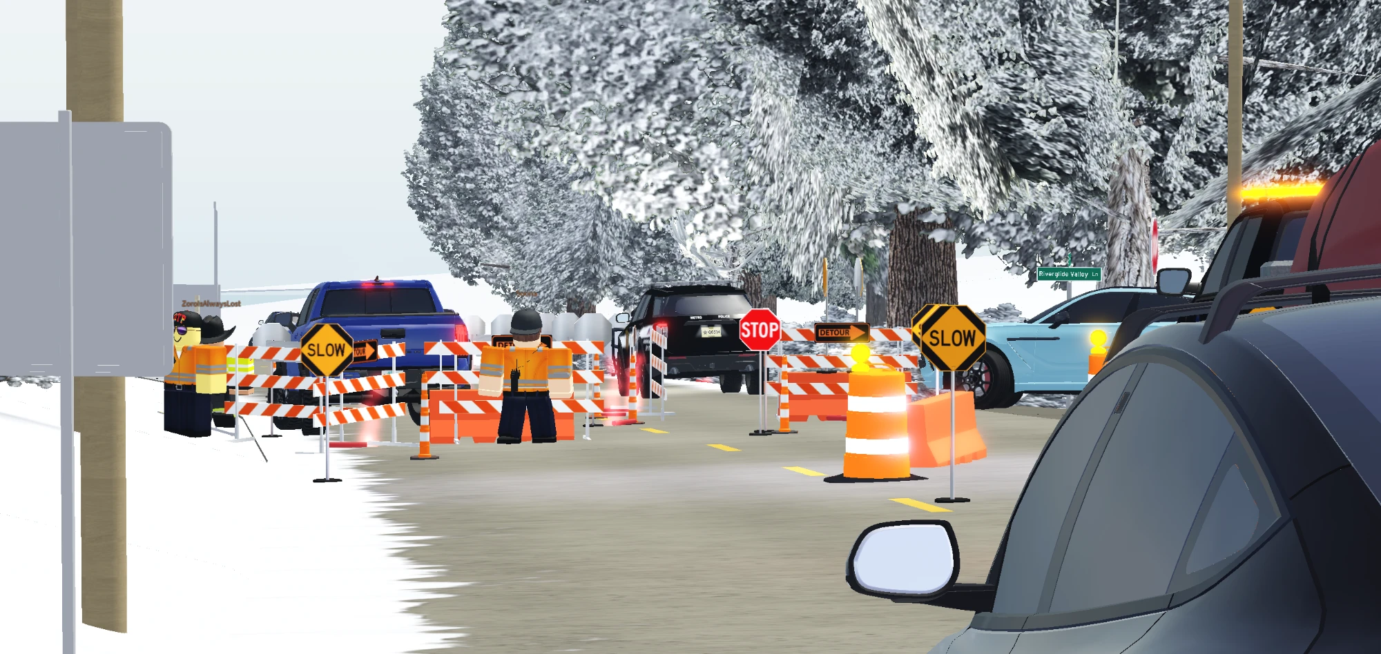 DOT flaggers directing traffic through a work zone with slow and stop signs.