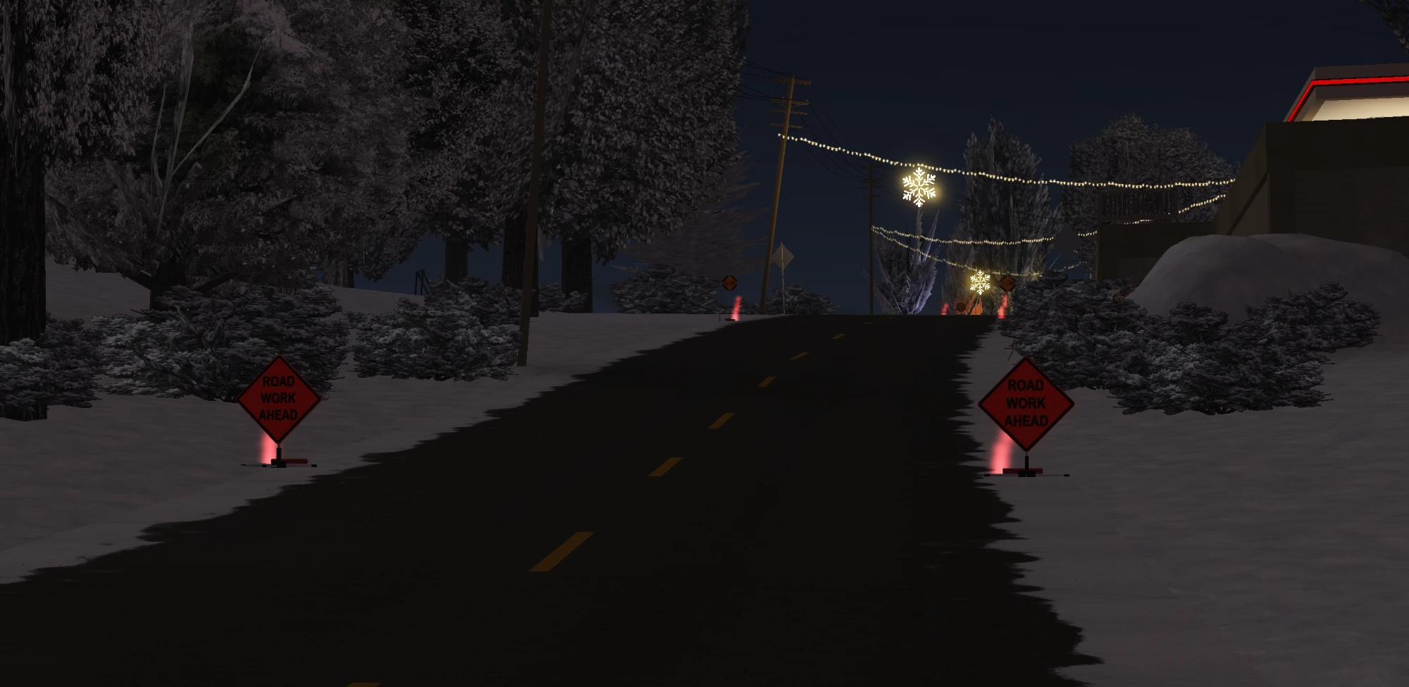 “Road Work Ahead” signs on a snowy road at night.
