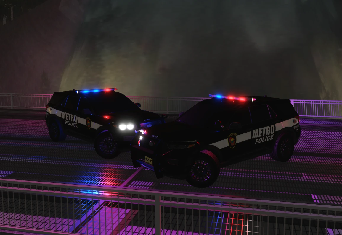 Two Metro Police SUVs with lights on at night.