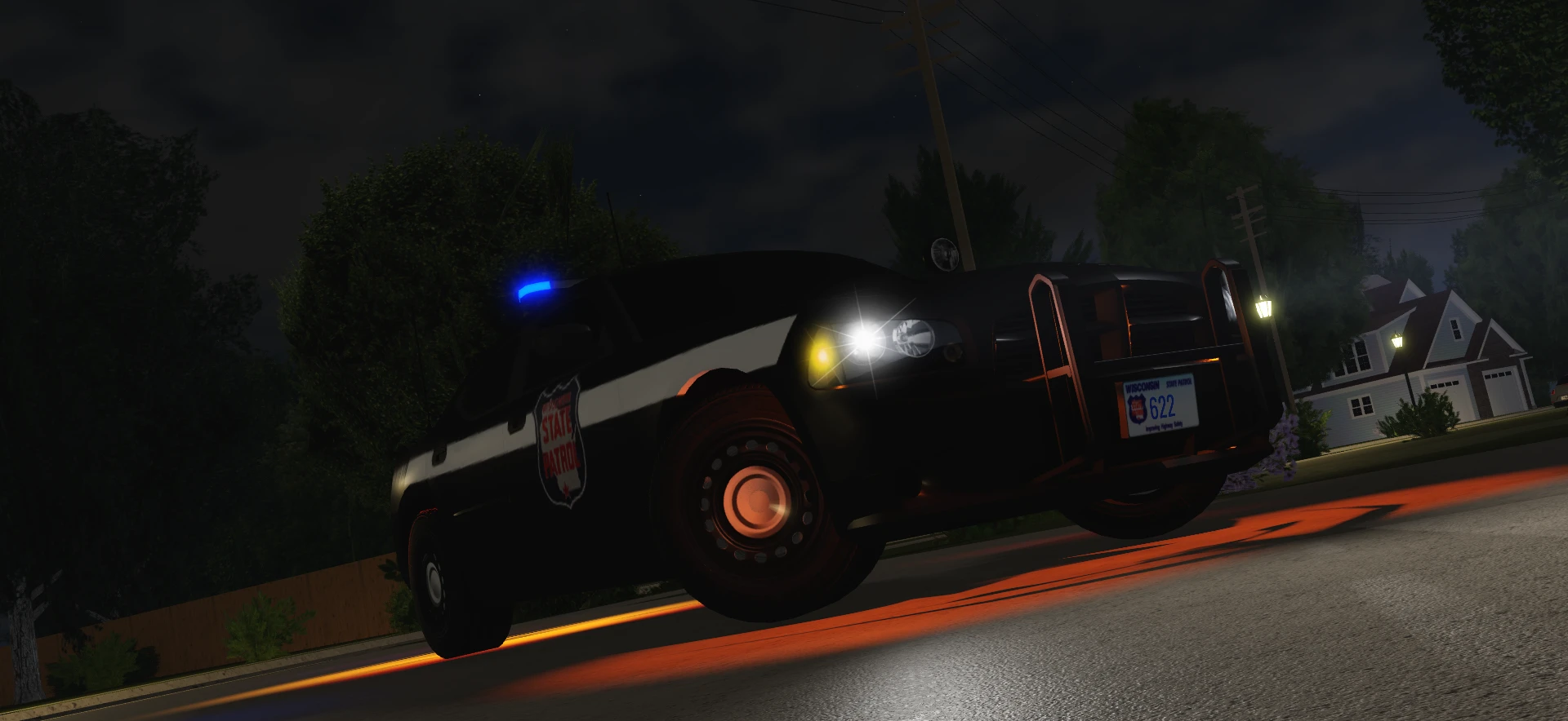 A Wisconsin State Patrol cruiser at night.